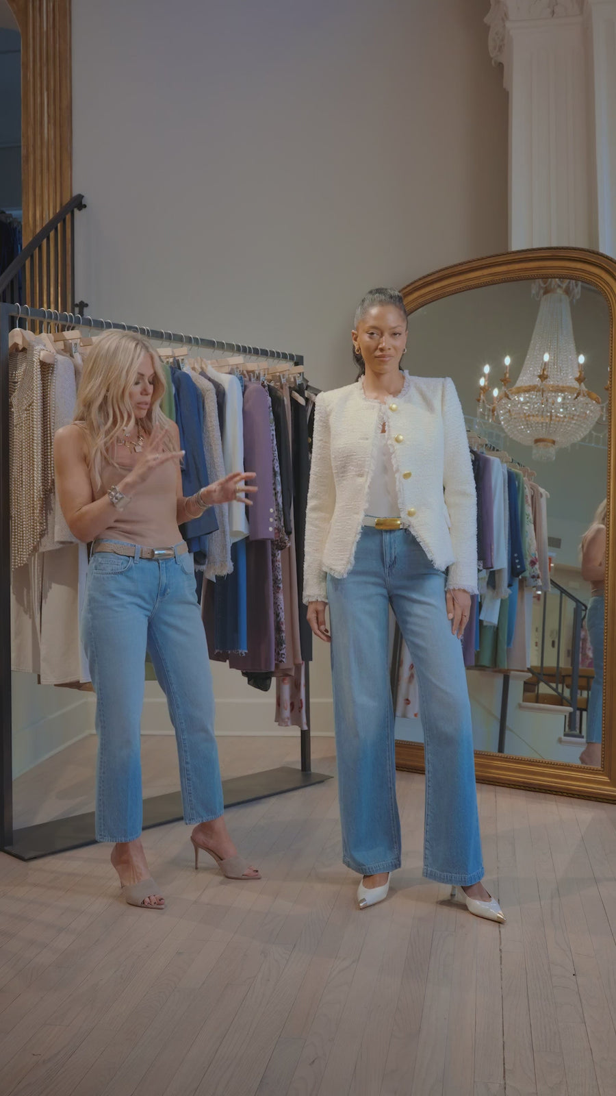 Tara Rudes Dann is showing off a model's white jacket with a pair of blue wide jeans